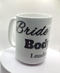 This “Bride Body Loading” mug is a white ceramic mug designed to celebrate a bride’s fitness journey as she prepares for her wedding. The mug features the phrase “Bride Body Loading” and a picture of a ring.