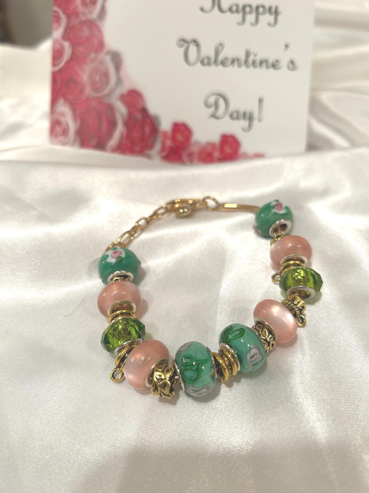 Green, pink and gold-beaded bracelet.
