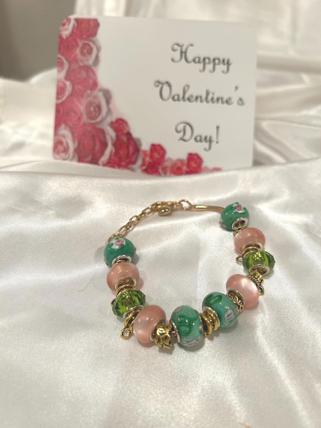 Green, pink and gold-beaded bracelet.
