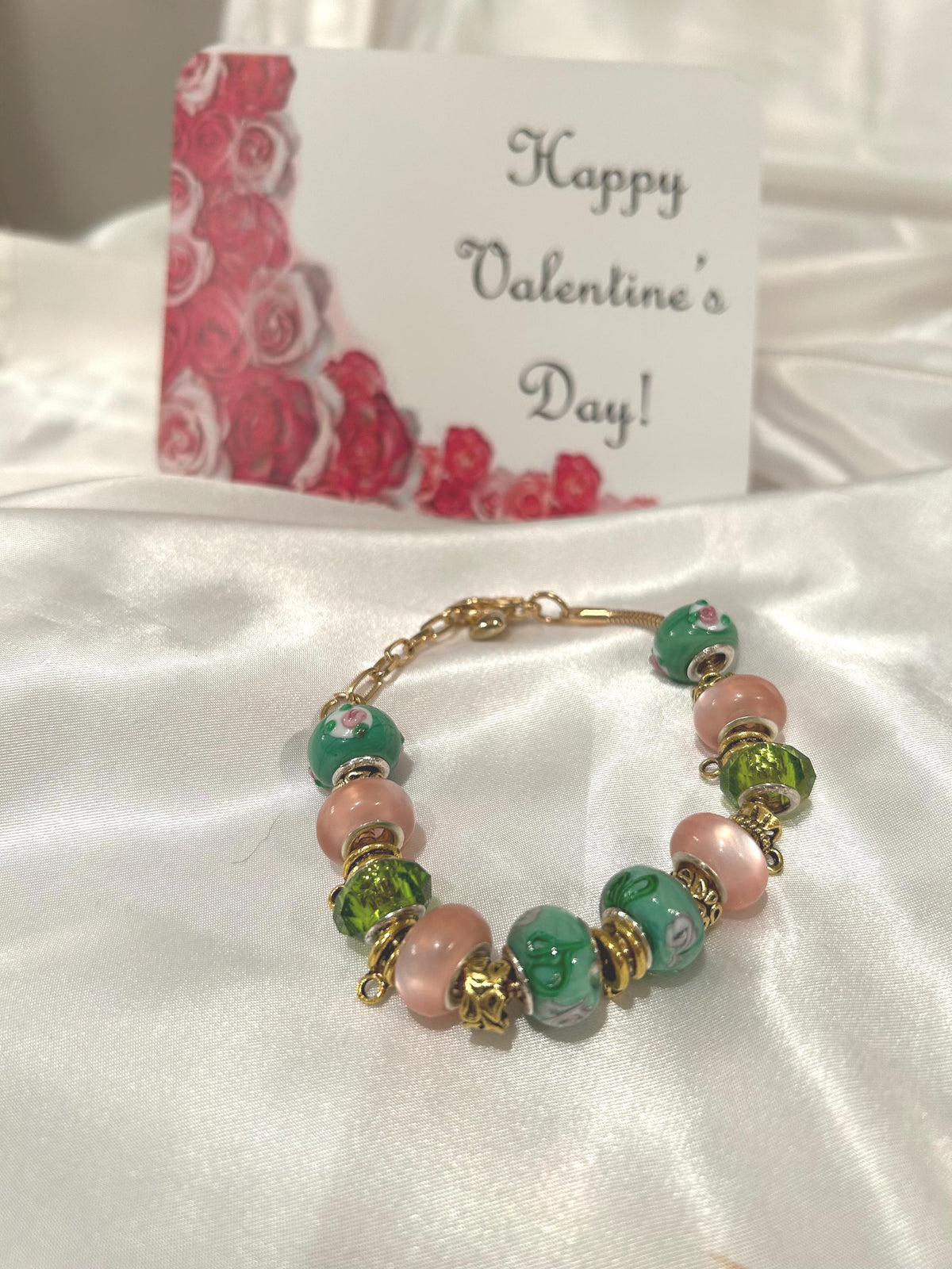 Green, pink and gold-beaded bracelet.