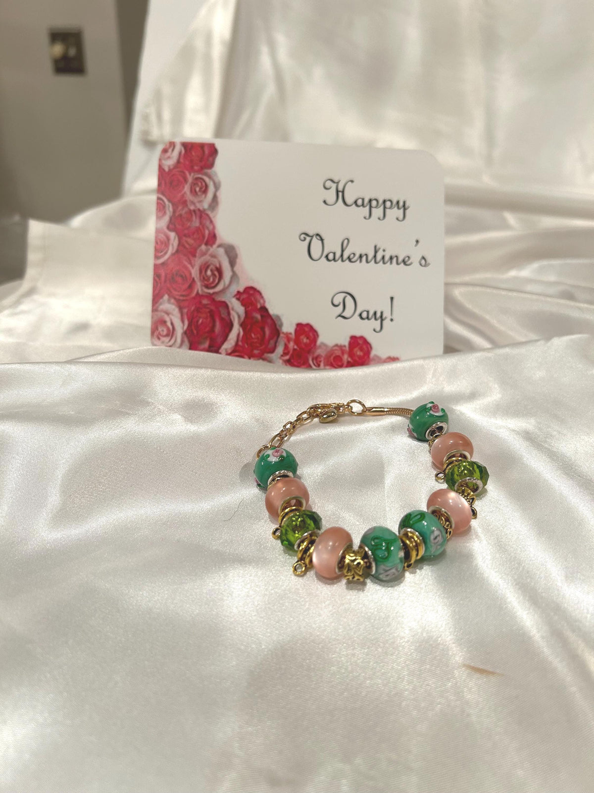 Green, pink and gold-beaded bracelet.