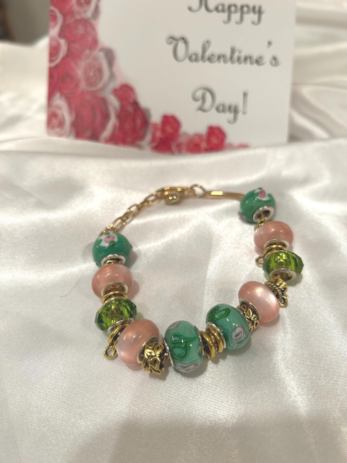 Green, pink and gold-beaded bracelet.