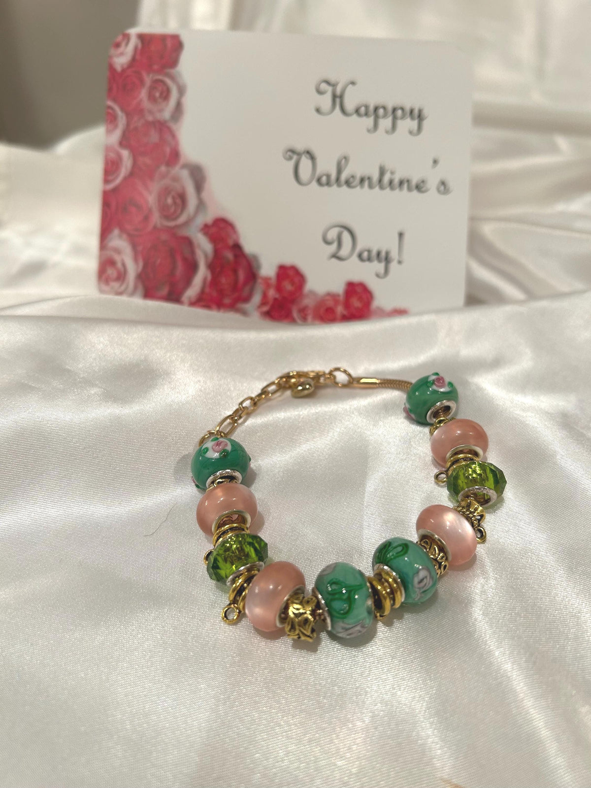 Green, pink and gold-beaded bracelet.