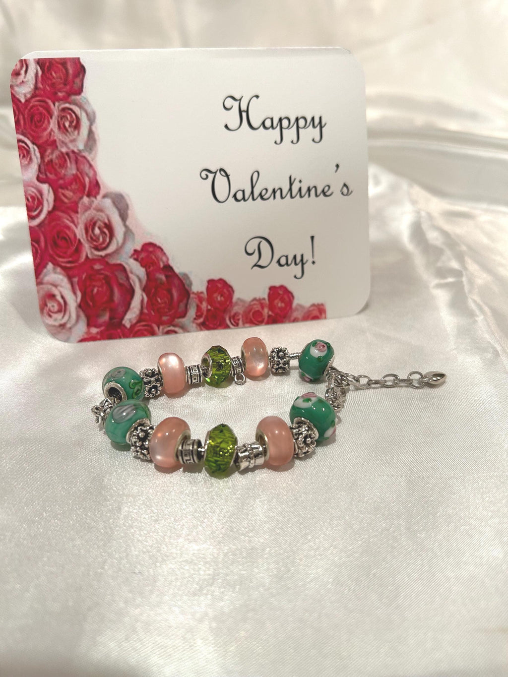Green, pink and gold-beaded bracelet.