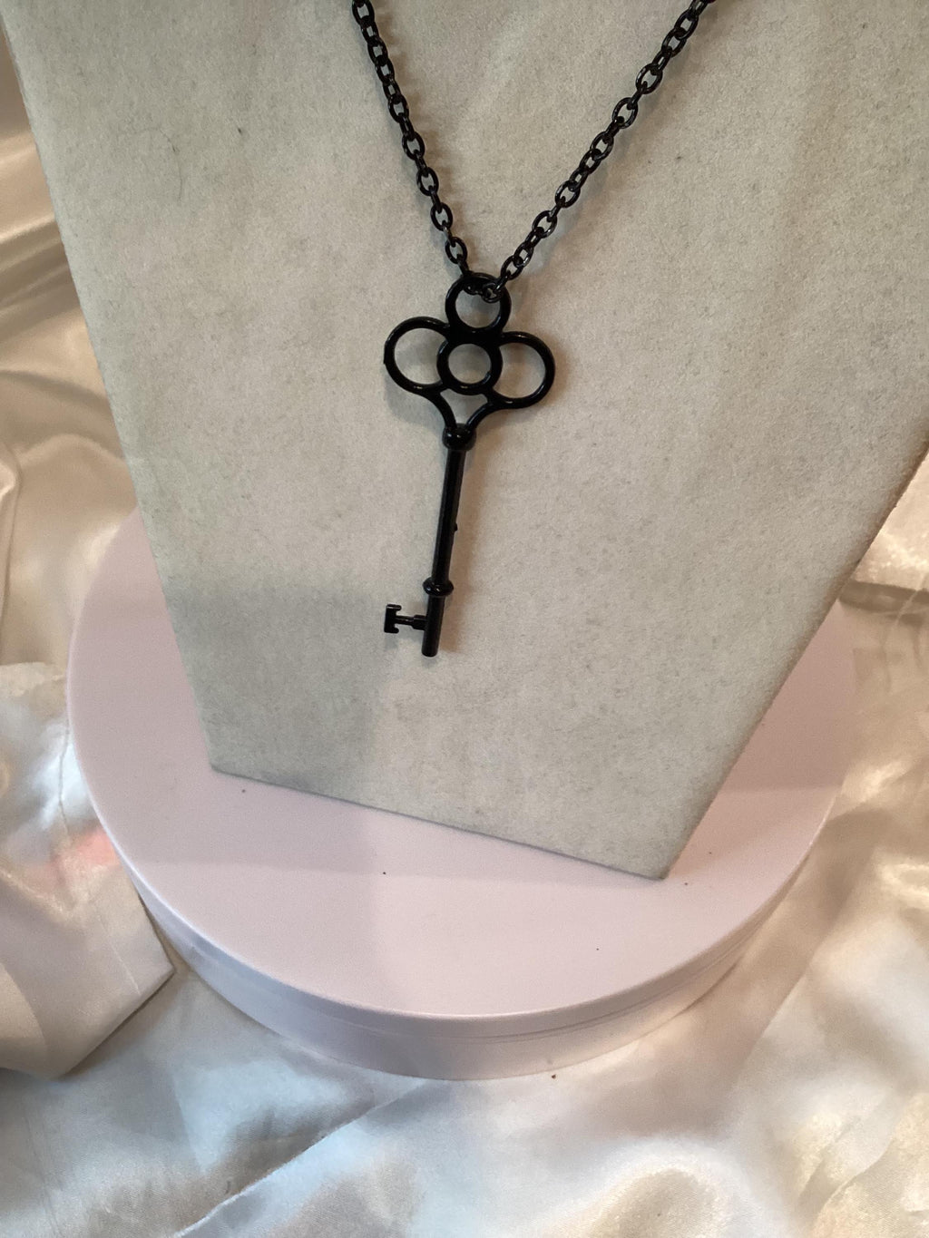 Black key pendant on a black chain