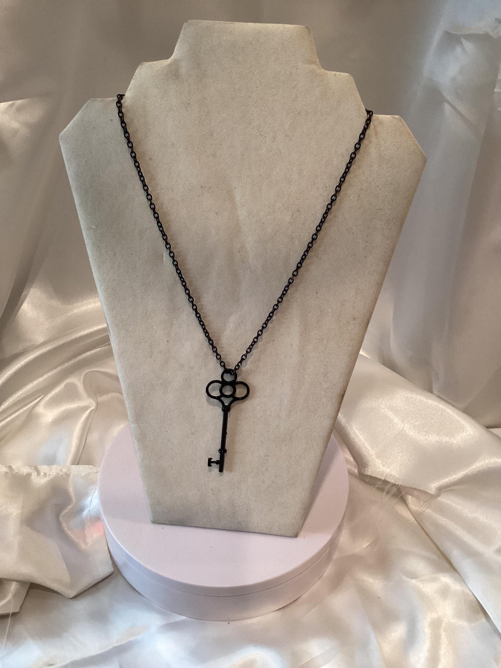 Black key pendant on a black chain