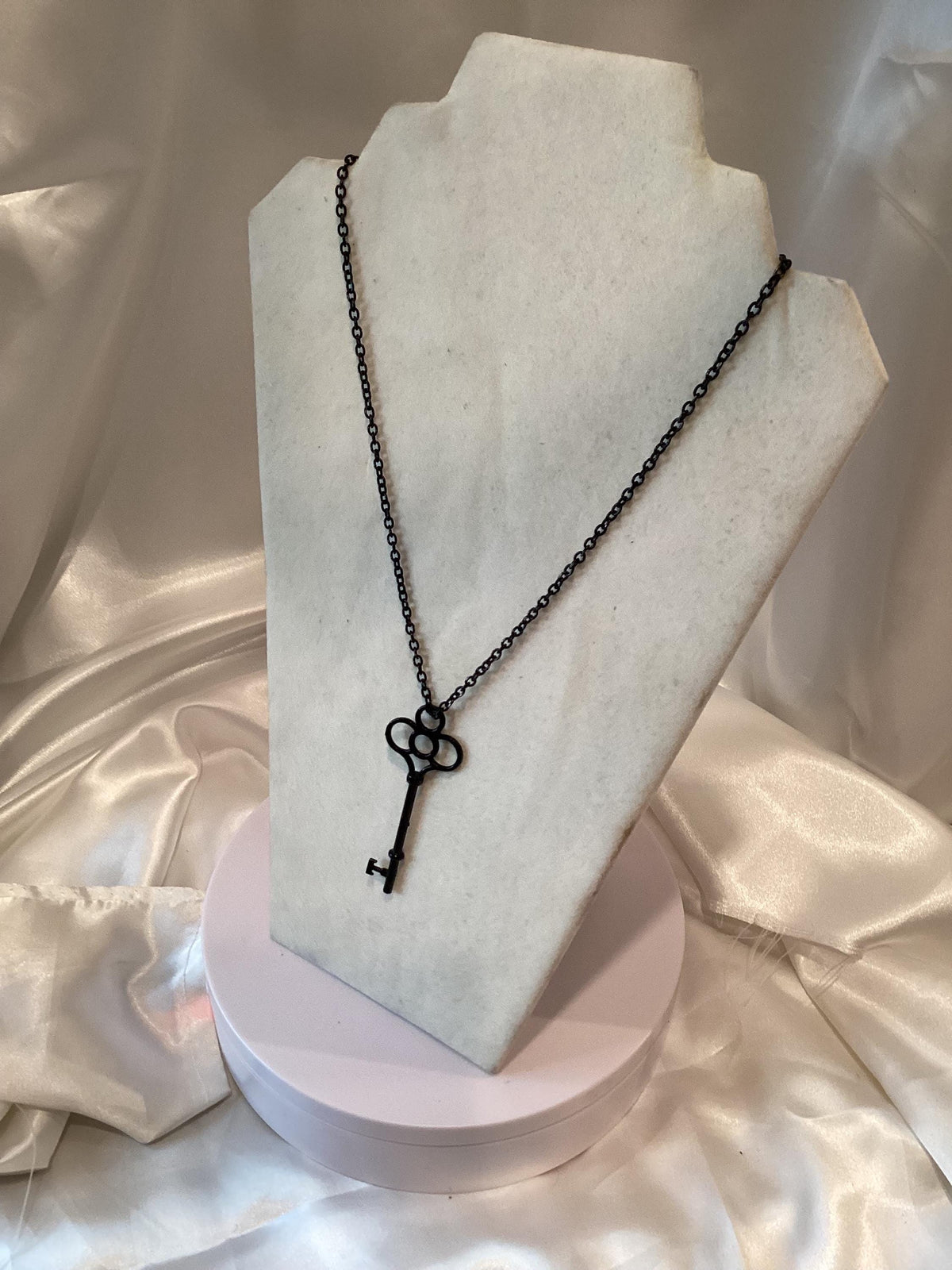 Black key pendant on a black chain