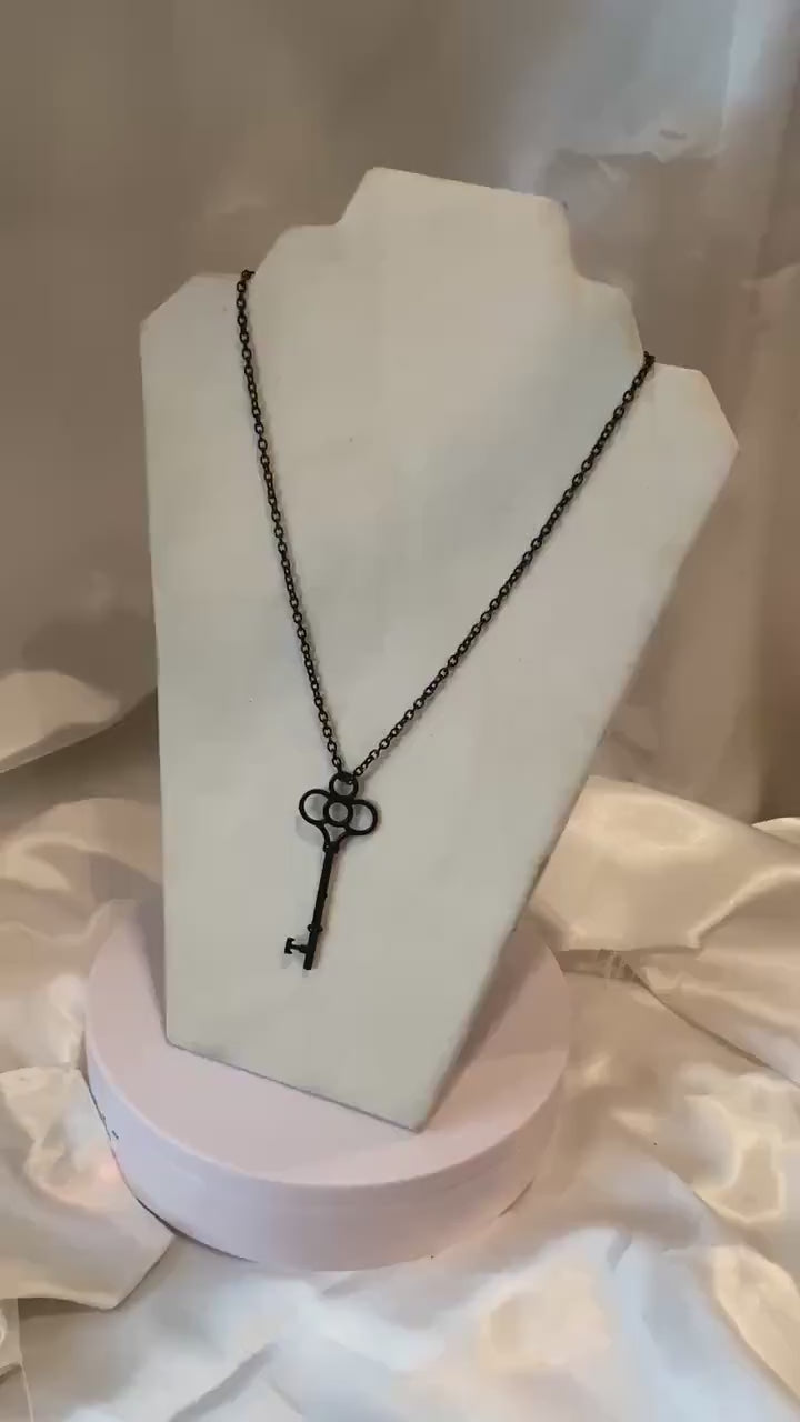 Black Key Pendant On A Black Chain